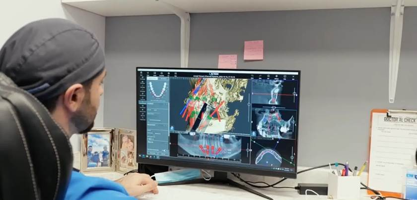 Dentist reviewing 3D imaging for a single dental implant