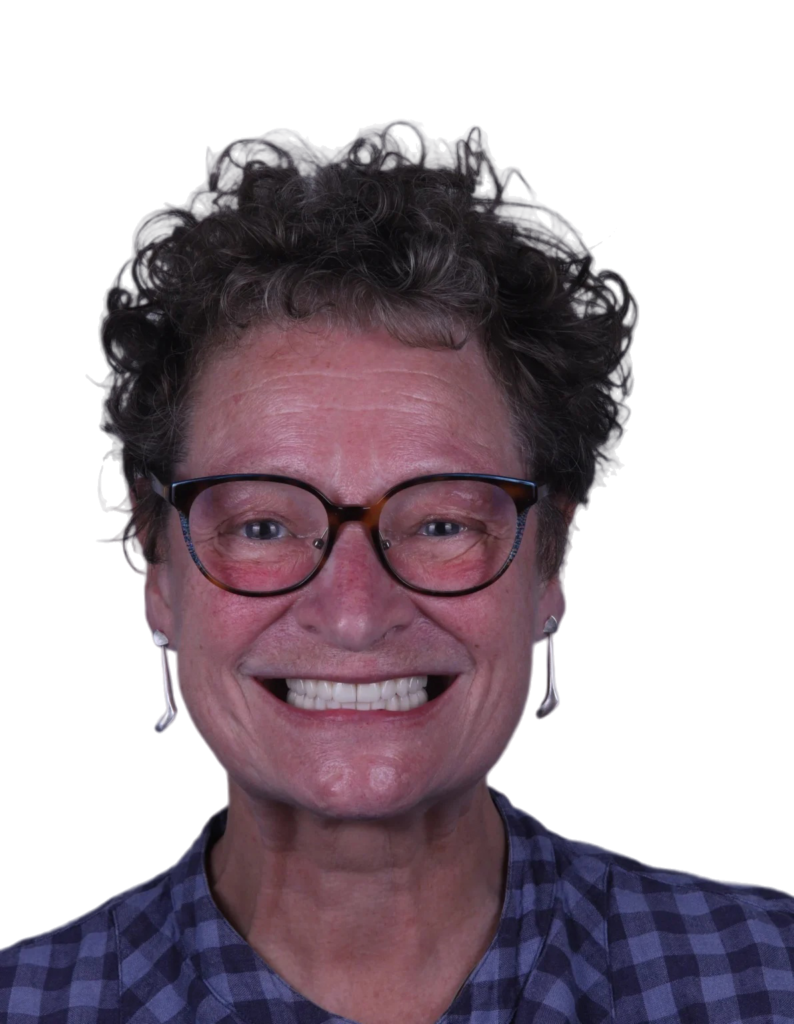 Smiling patient wearing complete dentures after prosthodontic rehabilitation